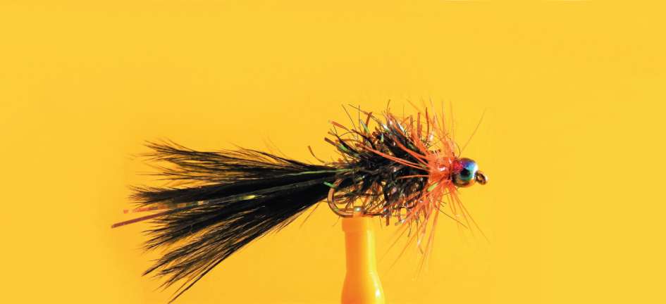 Widowmaker fly pattern in orange and black color combination on orange background.