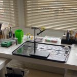 Organised fly tying desk with tools and materials neatly arranged for efficient fly tying.